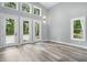 Well-lit living area with large windows and luxury vinyl plank flooring at 2921 Wall Store Rd, Garner, NC 27529
