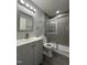 Bathroom featuring gray walls, a framed shower and gray vanity at 3030 Forrester St, Durham, NC 27704