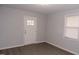 Bedroom featuring wood-look floors, white trim, and natural light at 3030 Forrester St, Durham, NC 27704