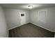 Bedroom featuring wood-look floors, white trim and an exterior door at 3030 Forrester St, Durham, NC 27704