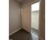 View of open closet with bifold doors and gray wood-look floors at 3030 Forrester St, Durham, NC 27704
