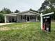 Charming single-story home with an inviting covered porch and a 'For Sale' sign at 3030 Forrester St, Durham, NC 27704