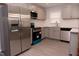 Modern kitchen with stainless steel appliances, gray cabinetry, subway tile backsplash, and new flooring at 3030 Forrester St, Durham, NC 27704