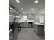 Bright kitchen featuring stainless steel appliances, marble countertops, and a gray kitchen island at 3030 Forrester St, Durham, NC 27704