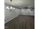 Bright living room featuring gray walls, dark floors, a modern chandelier, and recessed lighting at 3030 Forrester St, Durham, NC 27704