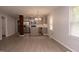 Open-concept living area featuring gray walls and flooring adjacent to the modern kitchen with gray cabinetry at 3030 Forrester St, Durham, NC 27704