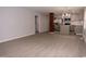 Spacious living room featuring gray walls and flooring adjacent to the modern kitchen at 3030 Forrester St, Durham, NC 27704