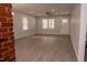 Bright living room with gray walls, recessed lighting, and adjacent kitchen with brick column at 3030 Forrester St, Durham, NC 27704