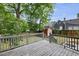Back deck with grey painted wooden railing overlooking fenced yard with shed at 304 Linden Ave, Raleigh, NC 27601