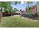 Expansive green back yard with wooden fence and gray back deck at 304 Linden Ave, Raleigh, NC 27601