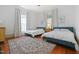 Inviting bedroom featuring two beds, hardwood floors, neutral walls, and sunlit windows at 304 Linden Ave, Raleigh, NC 27601