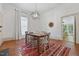 Dining room featuring wood floors, bright light, and access to kitchen at 304 Linden Ave, Raleigh, NC 27601