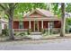 Charming red house with a cozy front porch and well-maintained landscaping at 304 Linden Ave, Raleigh, NC 27601