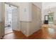 Hallway showcasing hardwood floors, neutral wainscoting, closet, and inviting doorways to other rooms at 304 Linden Ave, Raleigh, NC 27601