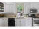 Functional kitchen with white cabinets, a stainless steel range, and modern appliances at 304 Linden Ave, Raleigh, NC 27601