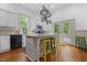 Open kitchen with an island, stainless steel appliances, and access to the deck at 304 Linden Ave, Raleigh, NC 27601