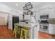 Well-lit kitchen featuring an island with seating and stainless steel appliances at 304 Linden Ave, Raleigh, NC 27601