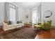 Bright living room with wood floors, neutral furniture and abundant natural light at 304 Linden Ave, Raleigh, NC 27601