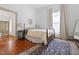 Main bedroom with wood floors, white walls, and an ensuite bathroom at 304 Linden Ave, Raleigh, NC 27601