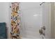 Bright bathroom shower with fresh white subway tile and colorful floral-themed shower curtain at 304 Linden Ave, Raleigh, NC 27601