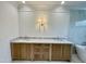 Bathroom featuring double sink vanity, marble countertops, wood cabinets, decorative wall lighting, and a bathtub at 323 Hudson St, Raleigh, NC 27608