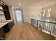 Bright landing features hardwood floors, chandelier, stairs, and a wet bar at 323 Hudson St, Raleigh, NC 27608