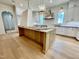 Kitchen island with light colored marble top, wooden base, and stainless steel sink at 323 Hudson St, Raleigh, NC 27608