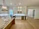 Kitchen with white cabinets, an arched doorway, and a central island at 323 Hudson St, Raleigh, NC 27608