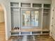 Convenient mudroom offers integrated shelving, a window seat, and storage solutions at 323 Hudson St, Raleigh, NC 27608