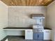 Elegant outdoor kitchen boasts a built-in grill, counter space, white cabinets, and modern fixtures at 323 Hudson St, Raleigh, NC 27608