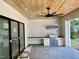 Elegant outdoor kitchen with stone floors, a wood ceiling, stainless steel grill, and modern fixtures at 323 Hudson St, Raleigh, NC 27608