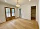 Empty room with double doors leading to a closet and beautiful light fixture at 323 Hudson St, Raleigh, NC 27608