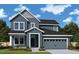 Charming two-story home with a two-car garage, a cozy front porch, manicured landscaping, and beautiful curb appeal at 33 Cozy Hvn, Fuquay Varina, NC 27526