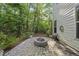 Backyard stone patio with fire pit, perfect for outdoor entertaining, surrounded by mature trees at 359 Ashton Ridge Ln, Cary, NC 27513