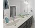 Close-up of the vanity with a large mirror, double sinks, and gray cabinets in a well-lit bathroom at 359 Ashton Ridge Ln, Cary, NC 27513