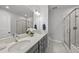 Well-lit bathroom featuring double sinks, modern fixtures, and a glass-enclosed shower at 359 Ashton Ridge Ln, Cary, NC 27513