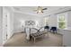 Cozy bedroom featuring a bed between two windows with two chairs and a bench at 359 Ashton Ridge Ln, Cary, NC 27513