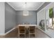 Dining room with modern chandelier, wooden table, and chairs, sliding door to the backyard at 359 Ashton Ridge Ln, Cary, NC 27513