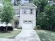 Charming two-story home with white brick and gray shutters, nestled in a lush green neighborhood at 359 Ashton Ridge Ln, Cary, NC 27513