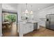 Open kitchen with stainless steel dishwasher, quartz countertops, and hardwood floors at 359 Ashton Ridge Ln, Cary, NC 27513