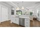Kitchen with a sink, stainless steel dishwasher, and quartz countertops overlooking living area at 359 Ashton Ridge Ln, Cary, NC 27513