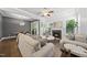 Cozy living room featuring comfortable seating around a fireplace and light from a sliding glass door at 359 Ashton Ridge Ln, Cary, NC 27513