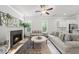 Bright living room features a fireplace, neutral furniture, and plenty of natural light from the nearby windows at 359 Ashton Ridge Ln, Cary, NC 27513