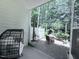 Cozy covered patio with an egg chair and a view of the secluded backyard and lush greenery at 359 Ashton Ridge Ln, Cary, NC 27513