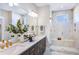 Modern bathroom features a double sink vanity, a glass-enclosed shower, and sleek fixtures at 361 Murray Grey Ln, Wake Forest, NC 27587