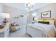 Charming bedroom with a metal bed frame, yellow accents and a sitting chair at 361 Murray Grey Ln, Wake Forest, NC 27587