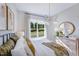 Comfortable bedroom with natural lighting, a decorative mirror, and stylish modern decor at 361 Murray Grey Ln, Wake Forest, NC 27587