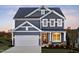 Charming two-story home with gray siding, a garage, and a beautifully landscaped front yard at 361 Murray Grey Ln, Wake Forest, NC 27587