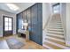 Elegant foyer with wood floors, paneled accent wall, staircase, and stylish console table at 361 Murray Grey Ln, Wake Forest, NC 27587