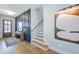 Chic foyer with wood floors, paneled wall, a staircase, and modern artwork displayed above a console table at 361 Murray Grey Ln, Wake Forest, NC 27587